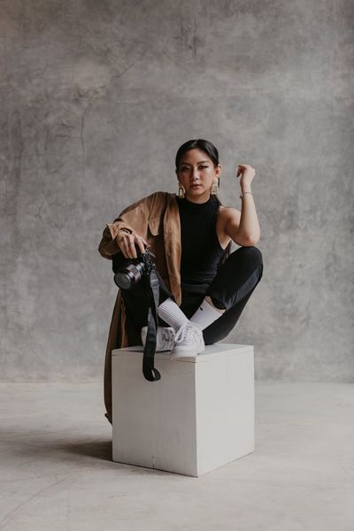 Person holding a balanced pose in a minimalist studio.